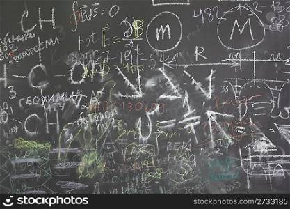 grey school chalkboard with many different formuls, signs and counts horizontal