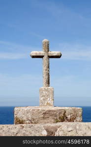 Grey stone cross on the Spanish coast