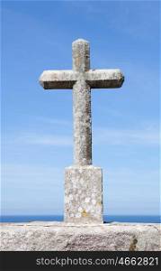 Grey stone cross on the Spanish coast