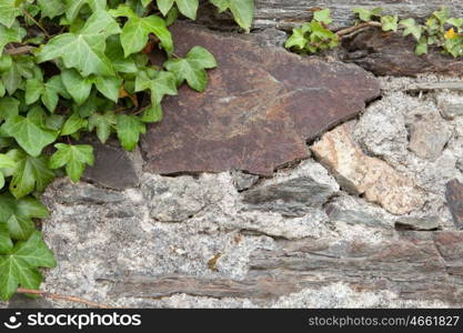 Grey wall of stone damaged by the passage of time