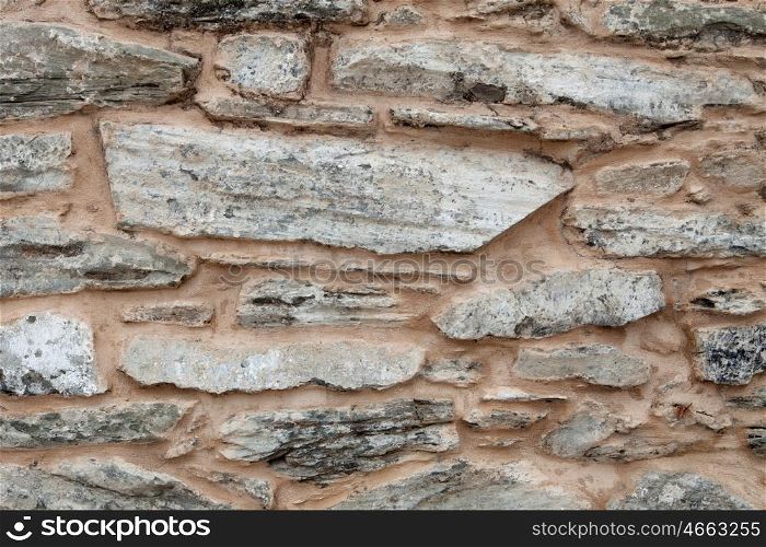 Grey wall of stone damaged by the passage of time