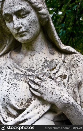 Grief. detail of an old tombstone showing a grieving woman