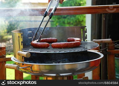 Grill sausages due to garden party.