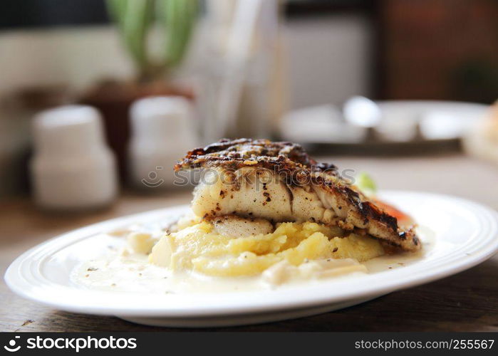 Grill sea bass fillets with crushed potatoes