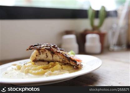 Grill sea bass fillets with crushed potatoes