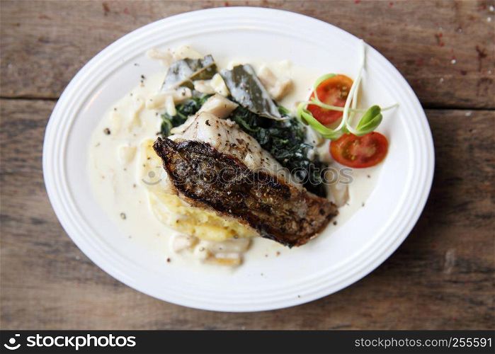 Grill sea bass fillets with crushed potatoes