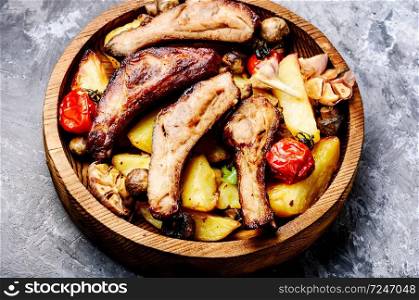Grilled barbecue pork rib with potatoes on wooden plate.Spareribs.. Delicious roasted ribs