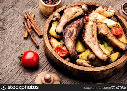 Grilled barbecue pork rib with potatoes on wooden plate.Spareribs.. Delicious roasted ribs