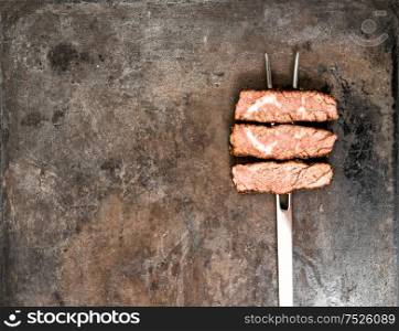 Grilled beef meat on rustic metal background. Food concept