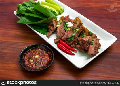 Grilled beef set with spicy Thai style dipping sauce. Close up