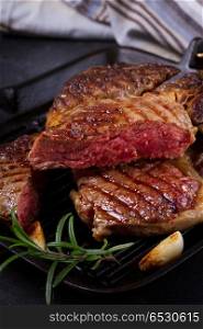 Grilled beef steak. Grilled beef steak with blood on dark background