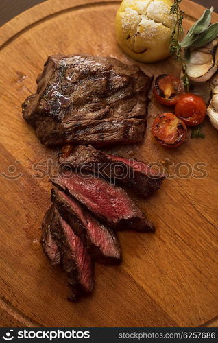 grilled beef steak. grilled beef steak with herbs and vegetables