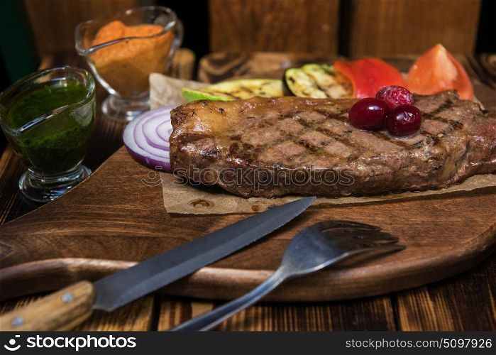 grilled beef steak. grilled beef steak with sauce and vegetables