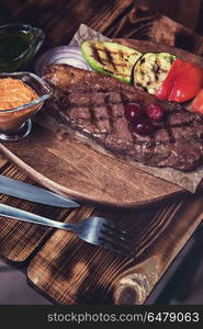 grilled beef steak. grilled beef steak with sauce and vegetables