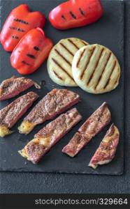 Grilled beef steak with bell peppers and cheese