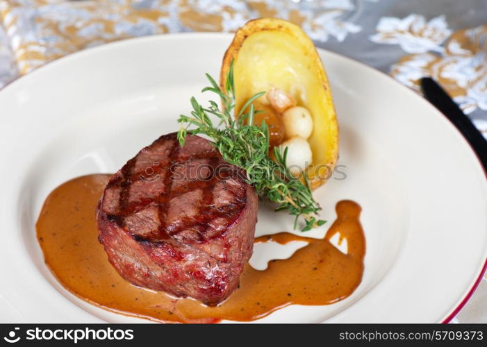 grilled beef steak with herbs and vegetables