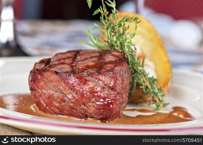 grilled beef steak with herbs and vegetables