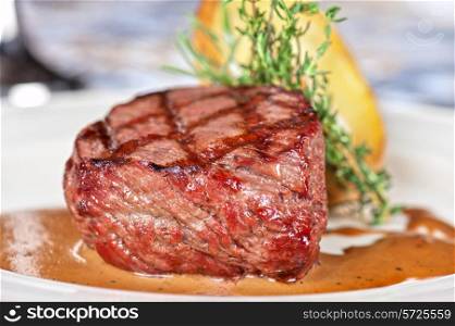 grilled beef steak with herbs and vegetables