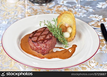 grilled beef steak with herbs and vegetables