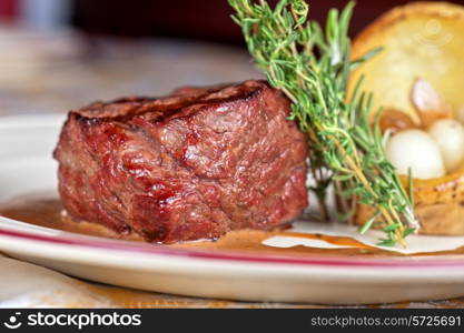 grilled beef steak with herbs and vegetables