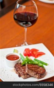 grilled beef steak with sauce and wine