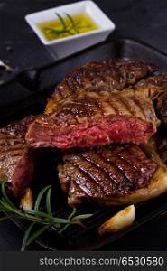 Grilled beef steak with spices on dark background. Grilled beef steak. Grilled beef steak