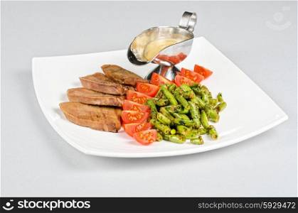 grilled beef tongue. grilled beef tongue with green beans and tomato cherry