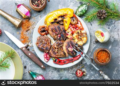 Grilled beef with vegetables to the Christmas table.Veal in pomegranate sauce.Christmas dinner. Christmas roast meat