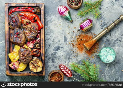 Grilled beef with vegetables to the Christmas table.Veal in pomegranate sauce.Christmas dinner. Christmas roast meat