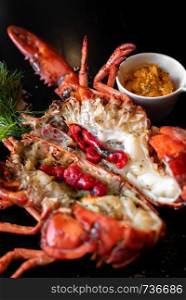 Grilled boston lobster serve with butter chilli sauce with lemon and salt.