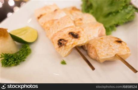 Grilled bottom part of Salmon with salt on white plate