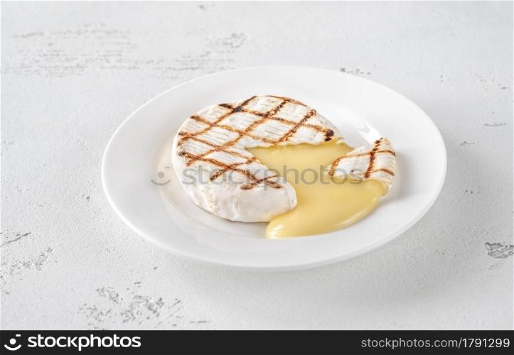 Grilled Camembert on the white plate: cross section