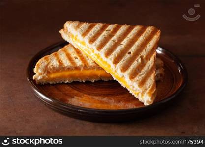 grilled cheese sandwich on rustic brown background