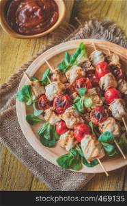 Grilled chicken and cherry tomato skewers on the plate