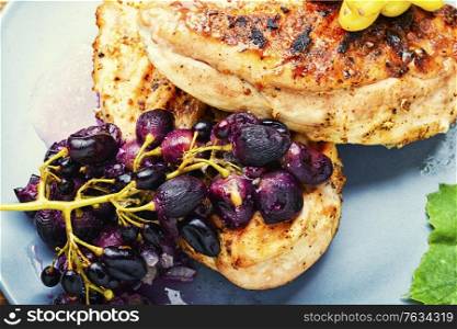 Grilled chicken breast marinated in grape sauce.Fried chicken fillet.Healthy food. Chicken roasted steak with grapes