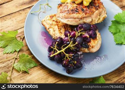 Grilled chicken breast marinated in grape sauce.Healthy food. Chicken roasted steak with grapes