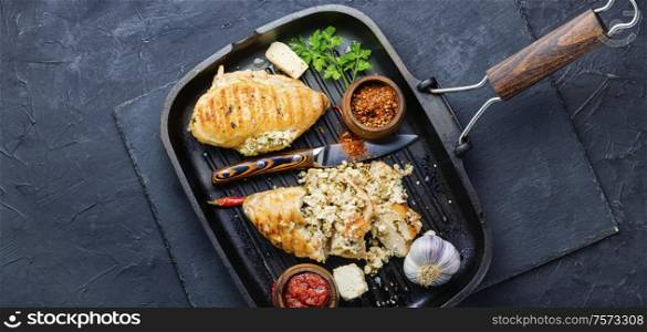 Grilled chicken breast stuffed with feta cheese and garlic.Chicken meat, sauce and seasoning in grill pan. Chicken breast with cheese