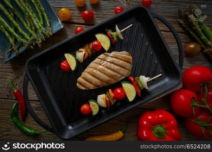 grilled chicken breast with brochette vegetable. grilled chicken breast with brochette vegetable on grill pan