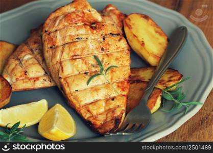Grilled chicken breast with fried potato and lemon .. Grilled chicken breast with fried potato and lemon