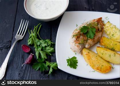 grilled chicken breast with roasted potatoes on white plate