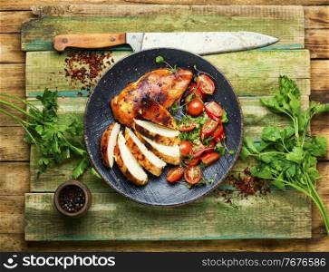 Grilled chicken breast with salad.Chicken breast on plate.Healthy food. Grilled chicken,chicken breast on rustic wooden table