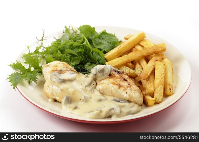 Grilled chicken breasts topped with a creamy mushroom sauce and served with french fried potato chips and a garden fresh green salad, side view