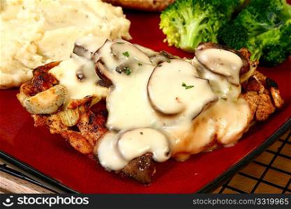 Grilled chicken covered in cheese sauce, portobello mushrooms and onions.