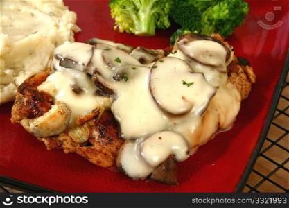 Grilled chicken covered in cheese sauce, portobello mushrooms and onions.
