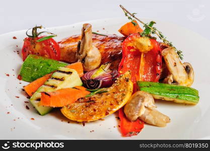 Grilled chicken fillet and big pieces of grilled vegetables. Not isolated.. Grilled chicken fillet and vegetables