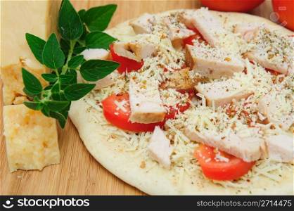 Grilled chicken, fresh tomatoes, garlic and grated Asiago cheese top this gournet pizza for one topped off with dried herbs and spices.. Un-cooked Chicken And Asiago Cheese Pizza