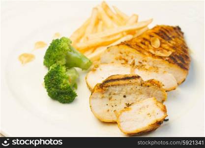 Grilled chicken. Grilled chicken with french fries and broccoli