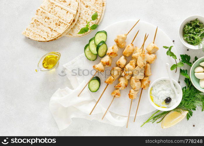 Grilled chicken kebab on skewers and traditional Greek tzatziki yogurt sauce, tview from above