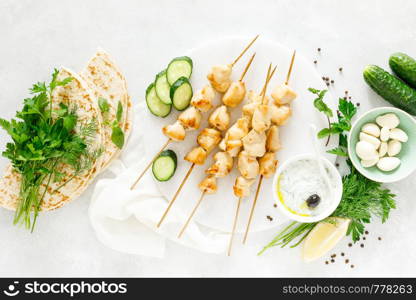 Grilled chicken kebab on skewers and traditional Greek tzatziki yogurt sauce, tview from above