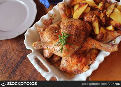 Grilled chicken leg, quarter with potato for garnish. Top view. Wooden background.. Grilled chicken leg, quarter with potato for garnish. Top view. Wooden background